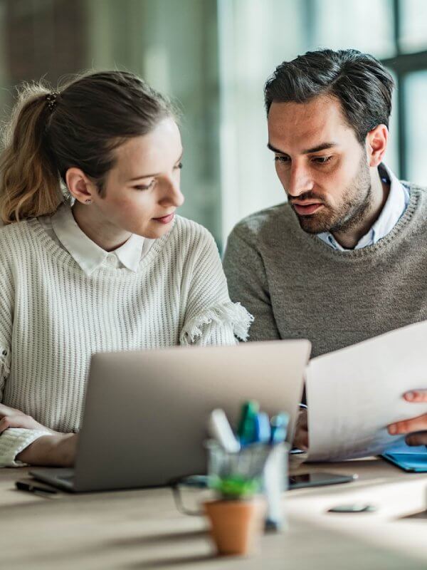Two colleagues looking at reports